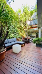 巴塞罗那ArtlifeBCN Urban Oasis Apartment的天井配有沙发、桌子和树木