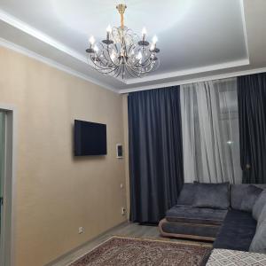 乔克-塔尔Иссык-Куль Кыргызстан, коттедж ЦО Палм Бич的带沙发和吊灯的客厅