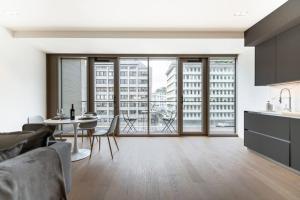 卢森堡Lux City Hamilius - Modern & Spacious Apart w/View的厨房以及带桌椅的起居室。