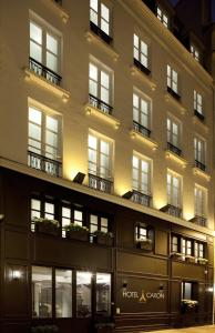 巴黎Hôtel Caron le Marais的一座在晚上有灯光的建筑