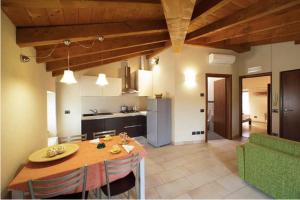 蒙赞巴诺La Casa del Nonno的厨房以及带桌子和绿色沙发的用餐室。