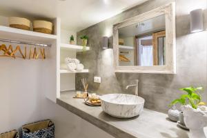 斯科派洛斯亚那小屋公寓的一间带大水槽和镜子的浴室