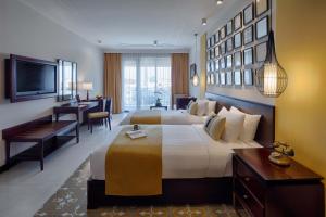 Allegro Hoi An . A Little Luxury Hotel & Spa客房内的一张或多张床位