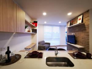 马尼萨莱斯Apartamento exclusivo en Manizales-Gran ubicación!的一个带水槽的厨房和一间客厅