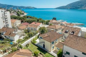 赫尔采格诺维Magnolia Apartments 2 Herceg Novi的享有小镇的空中景色,设有房屋和水