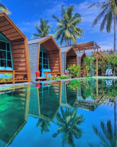 吉利特拉旺安Absolute Villa的一个带游泳池和棕榈树的度假村