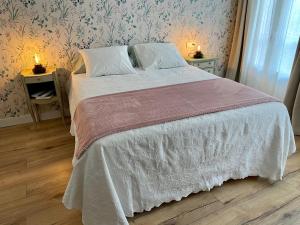 奥伦塞Casa da Fonte的一间卧室配有一张带白色被子和两盏灯的床。
