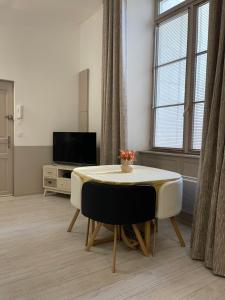 拉罗谢尔Apartment- La Rochelle historic city centre的客厅配有桌子和电视