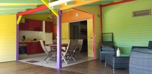 波尔兰特Gites Cabazat的色彩缤纷的房屋,配有桌椅