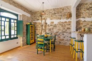 圣巴巴拉-迪内希Algarve Charming Rural 1br Villa的一间带绿色桌椅的用餐室