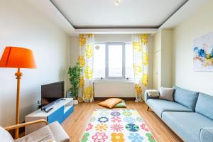 伊斯坦布尔Residance Flat With City View in Umraniye的客厅设有蓝色的沙发和窗户。