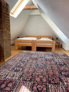 弗赖堡Ferienhaus Traminer im Weinberg的阁楼卧室配有床和地毯