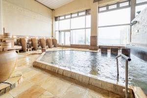 宫津市天桥立酒店的一个带椅子的酒店客房内的大型室内游泳池