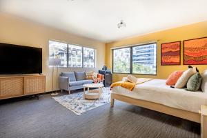 布里斯班Selina Brisbane的一间卧室配有一张床和一台平面电视