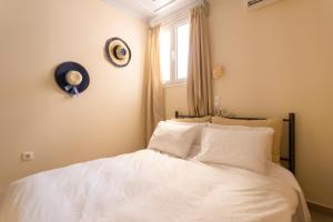 斯派赛斯Flash House的一间卧室配有一张带白色床单的床和一扇窗户。