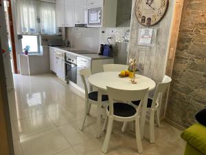 巴达洛纳BADAROSA House10min to BARCELONA City&NearTo BEACH的一间厨房,里面配有白色的桌子和椅子