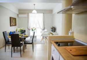 雅典Praxitelis Luxury Apartments的厨房以及带桌椅的用餐室。