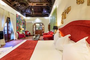 格拉纳达帕拉西奥德圣伊内斯酒店的一间带大床的卧室和一间客厅