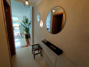 比韦罗Alojamientos Viveiro - Ático Playa de Covas的浴室设有一面镜子和一把椅子