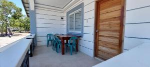 BulalaJCALM Beach resort的房屋内的小门廊配有桌椅