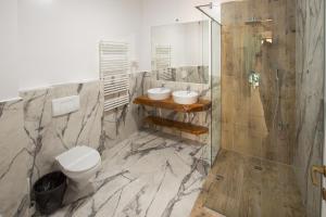 马马亚Lake Boutique Apartments & Rooms的浴室配有2个盥洗盆、卫生间和淋浴。