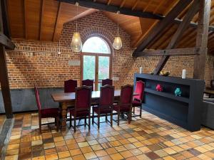 乌费Luxurious Mansion in N blon le Pierreux with Pool的一间带桌子和红色椅子的用餐室
