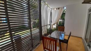 迪亚尼海滩Aqua Resort的客房设有桌子和带百叶窗的大窗户
