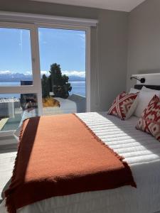 圣卡洛斯-德巴里洛切Acqua Apartments Bariloche的一间卧室设有一张床和一个大窗户
