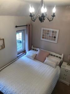 BebingtonCosy Rustic 3 bed cottage, great train links的卧室配有白色的床和窗户