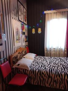茨卡尔图博Сибиряк的一间卧室设有斑马图案床和窗户