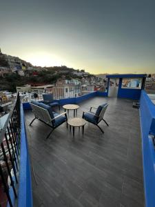 瓜纳华托Casa Dos Fridas - Centro Guanajuato的阳台配有桌椅,享有城市美景。