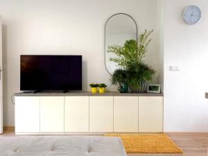 兹林Brunetti Villa Zlín的一间客厅,在白色的橱柜上配有电视