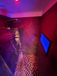 日沃尔Suite & Jacuzzi的一间带卫生间和蓝色灯光的浴室
