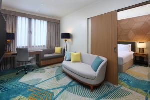 宿务Holiday Inn Cebu City, an IHG Hotel的酒店客房设有沙发、床和书桌