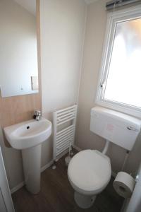 兹诺伊莫Merlin's camp的浴室配有白色卫生间和盥洗盆。