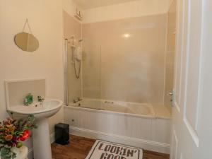 KilmartinSeaview-Barsloisnach Cottage的带淋浴、浴缸和盥洗盆的浴室