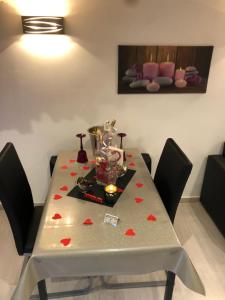 奥尔冈Appartement Love room avec jacuzzi et hammam privatisé Lieu insolite en amoureux Spa détente assurée avec de doux massages en options sur demande的一张红心餐桌