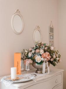 马尔米堡Villa Diletta b&b的一张桌子,上面放着花瓶和两面镜子