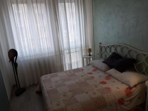 佛罗伦萨Appartamento Mamma Sandra, incantevole tre posti più uno的一间卧室配有床和带窗帘的窗户
