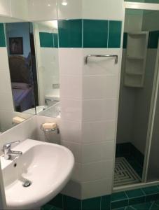 切尔沃港Appartamento Porto Cervo Dolce Sposa的浴室配有盥洗盆和带镜子的淋浴