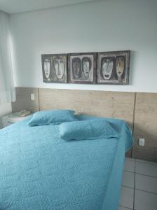 Flat Experience Marulhos Resort客房内的一张或多张床位