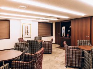 东京品川东武酒店的一间设有桌椅的等候室和一间酒吧