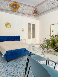 利帕里B&B Faraglione的卧室配有一张床和一张桌子及椅子