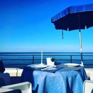 卡迪拉瓦尼亚悬崖酒店的一张桌子,上面有蓝色的桌布和雨伞