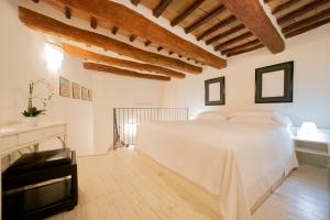 佩鲁贾乐斯坦斯迪伽利略酒店的卧室配有白色的床,铺有木地板