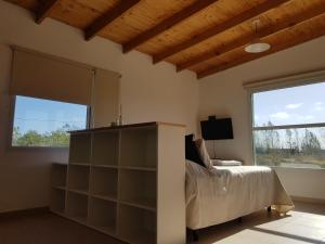 玛德琳港Coralillos的一间卧室设有一张床和一个大窗户