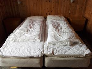 InnfjordenLensmansgarden Fjøsen的两张睡床彼此相邻,位于一个房间里