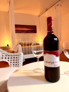 塞斯塔戈达诺Agriturismo I Prati di Venere的一张桌子上坐着一瓶葡萄酒和一杯