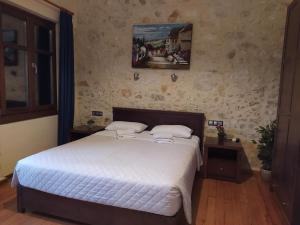 罗希姆诺Sea Front Old Town的卧室配有一张床,墙上挂有绘画作品