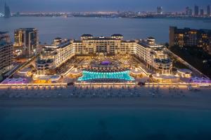迪拜Taj Exotica Resort & Spa, The Palm, Dubai的享有酒店空中景色,晚上设有游泳池